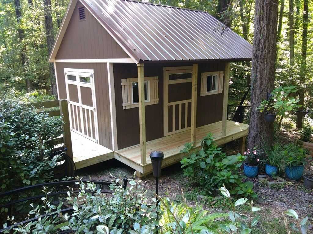 TR800 with a metal roof and porch surrounded by lush greenery