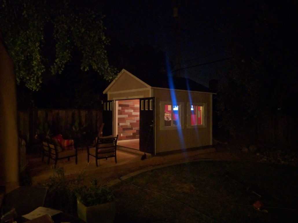 A 10 X 12 TR-800 shed is photographed at night, lit from within