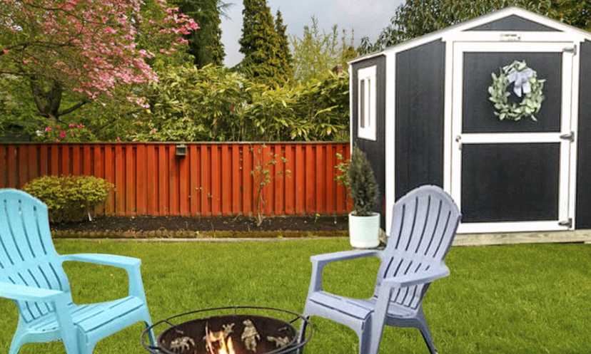 A black and white KR-600, Keystone shed, in a back yard, with two plastic chairs around a firepit