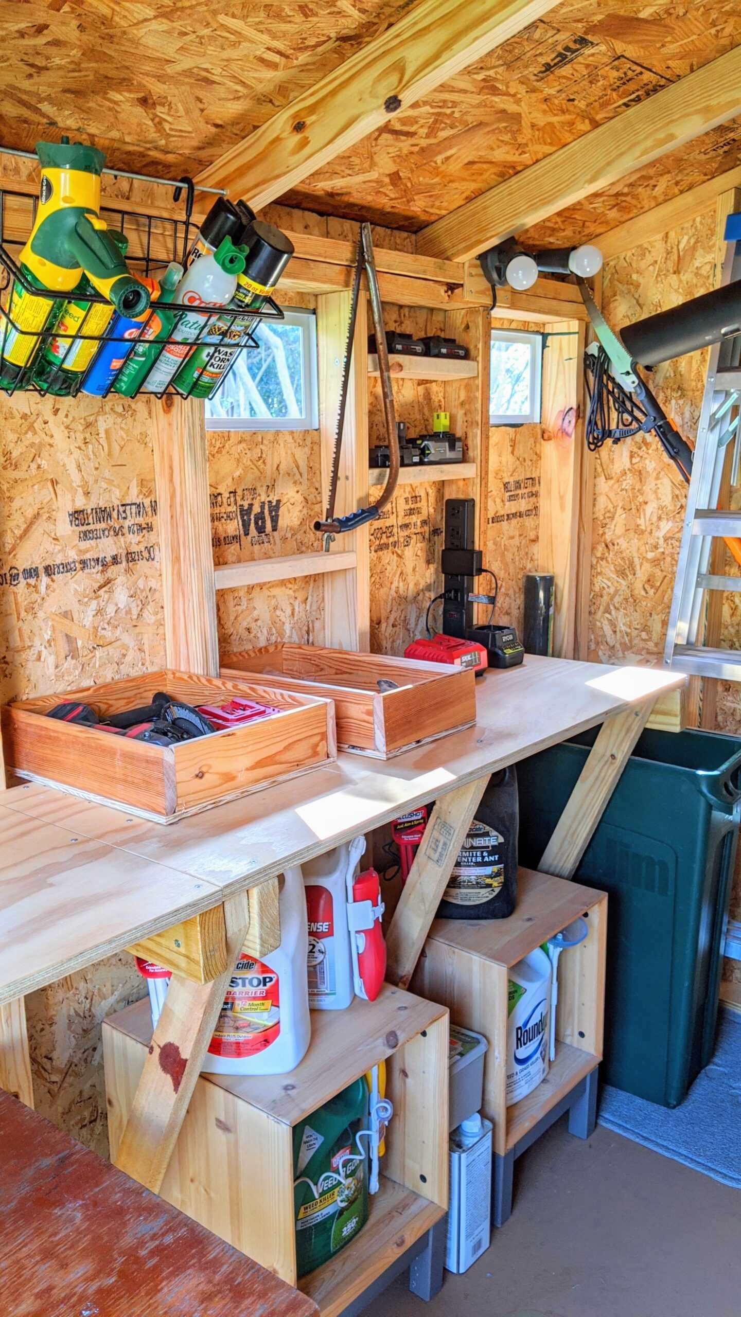 A shelf with a lot of tools and gardening gear.