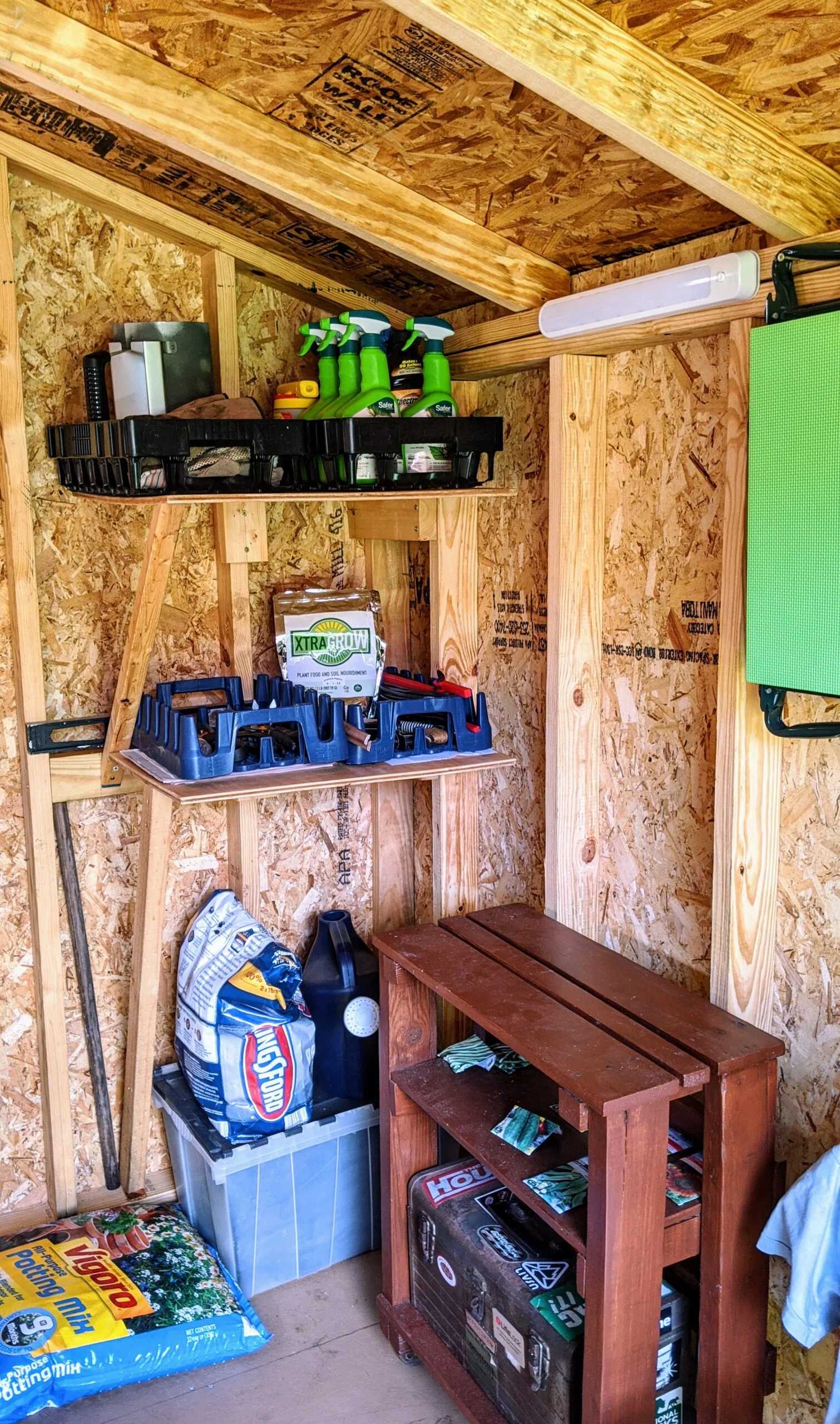 A SR-600 for storage for all your gardening gear, the person has shovels hanging and tools.