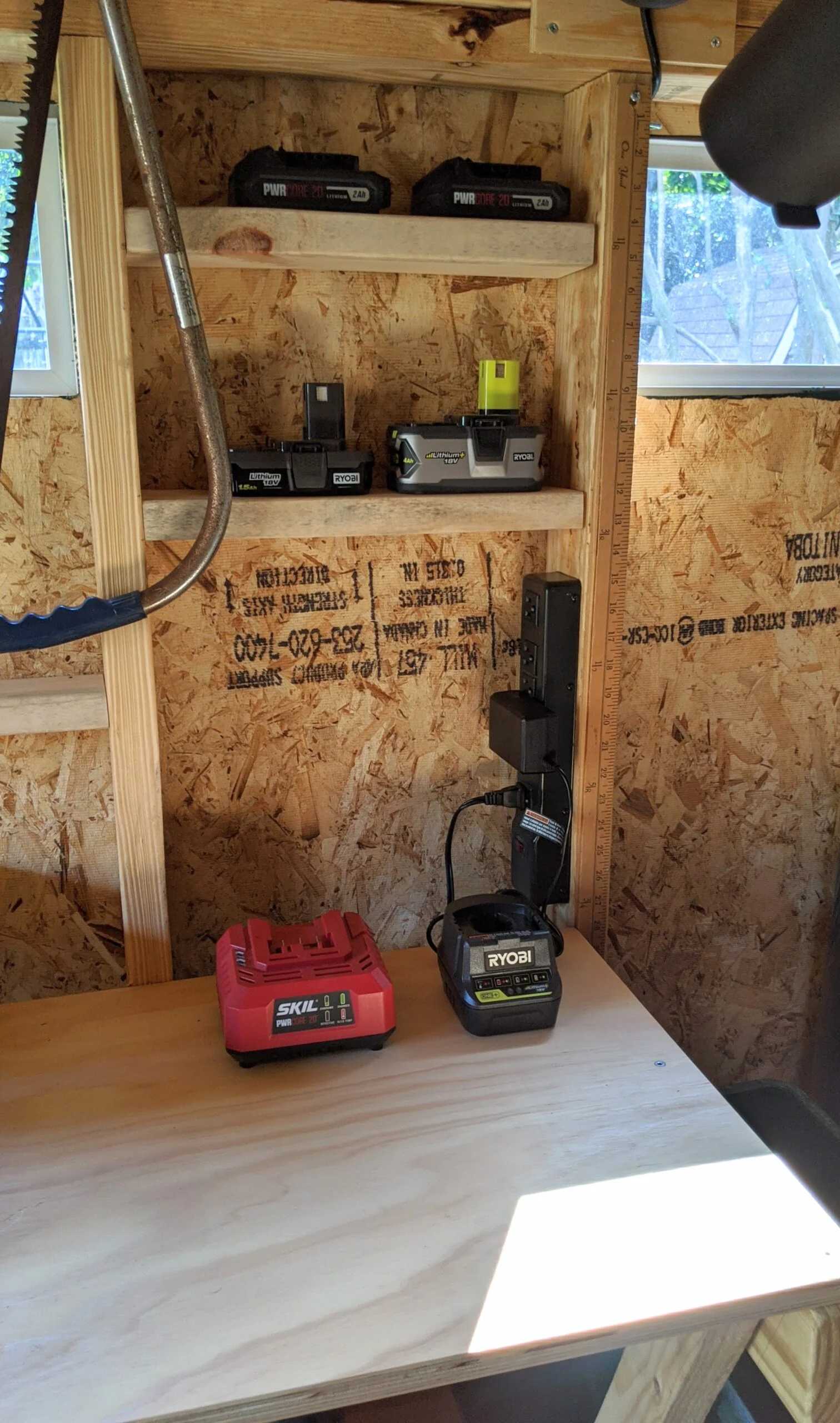 A SR-600 for storage for all your gardening gear, the person has shovels hanging and tools.