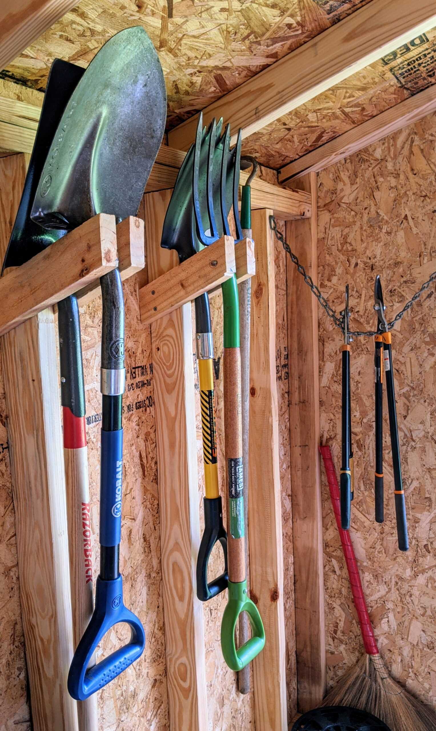 A SR-600 for storage for all your gardening gear, the person has shovels hanging and tools.