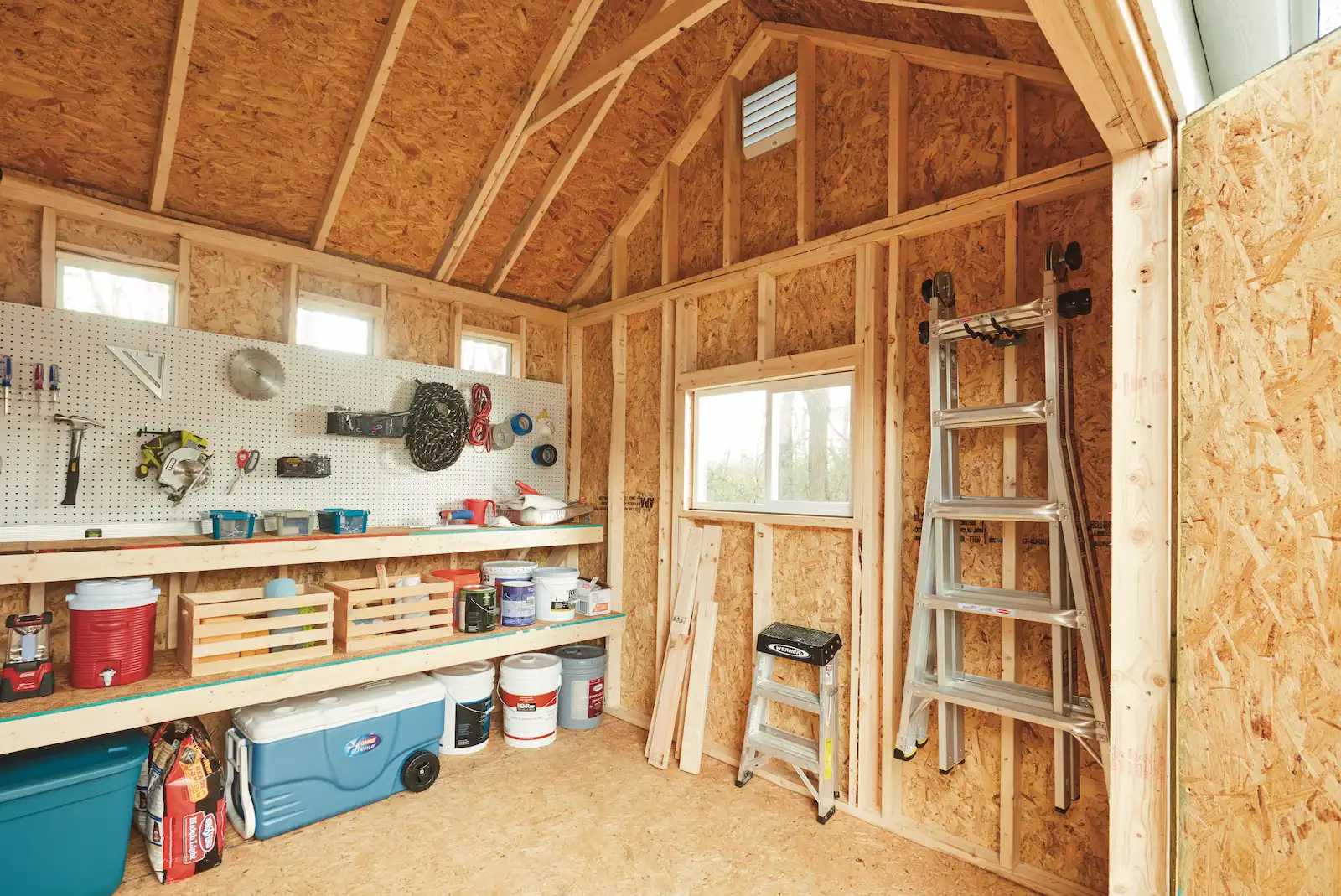 Interior of Tuff Shed with layers of shelving, hooks, and pegboard