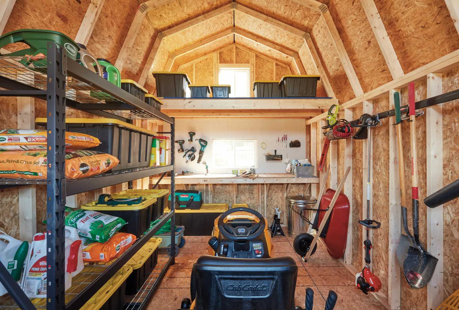 Interior of Tuff Shed building with shelving, loft, pegboard and more