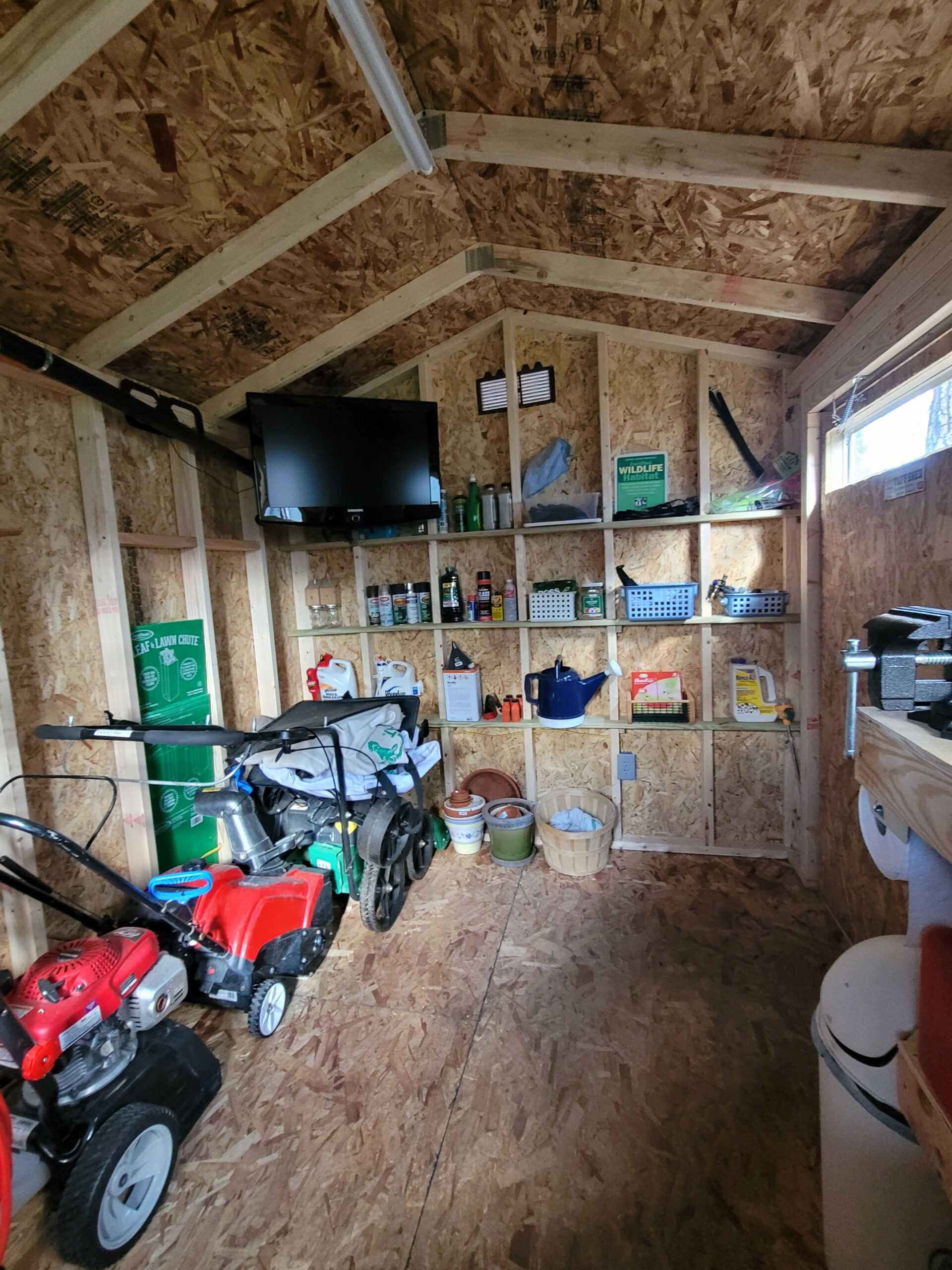 A TR-700 used for storage and a Man Cave. With a lawn mower and a TV.