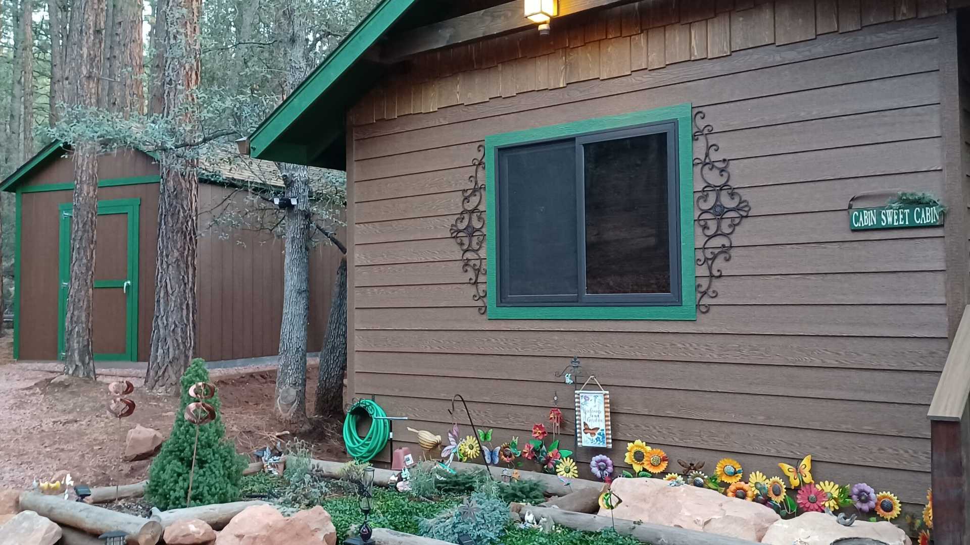 A TR-800 shed next to a cabin in the woods.