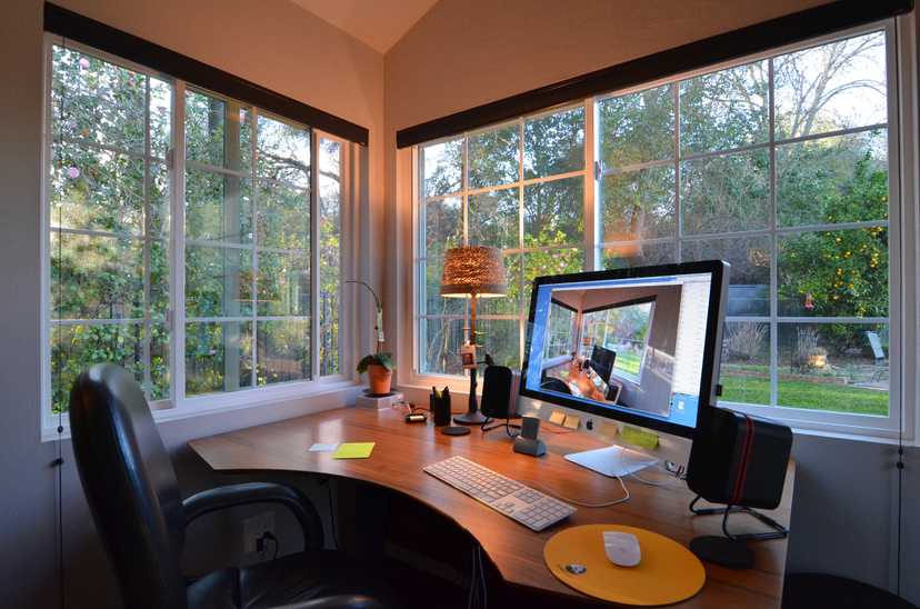 Interior view of a shed built out into an office looking into a backyard