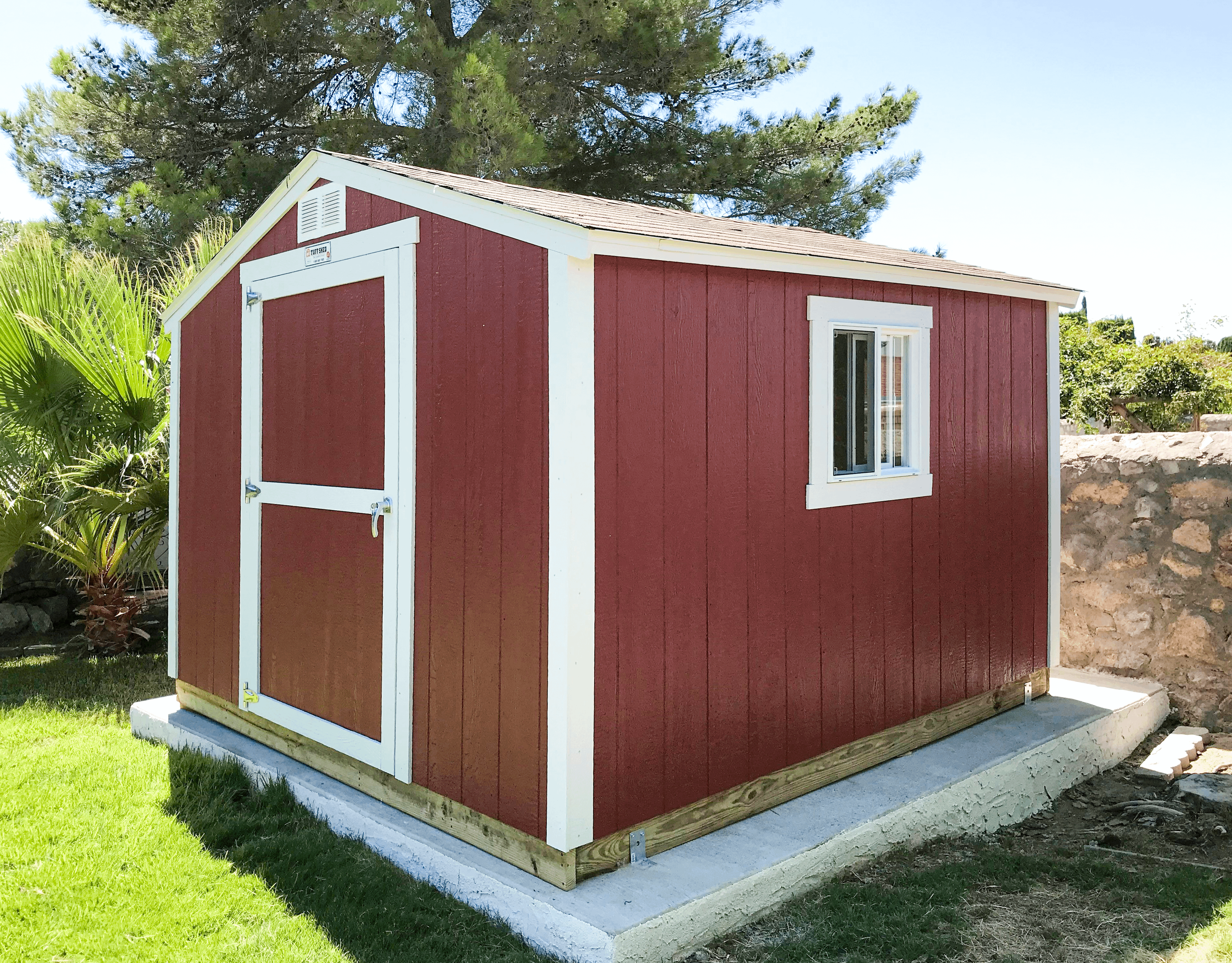 Red KR600 shed with white trim on a concrete platform