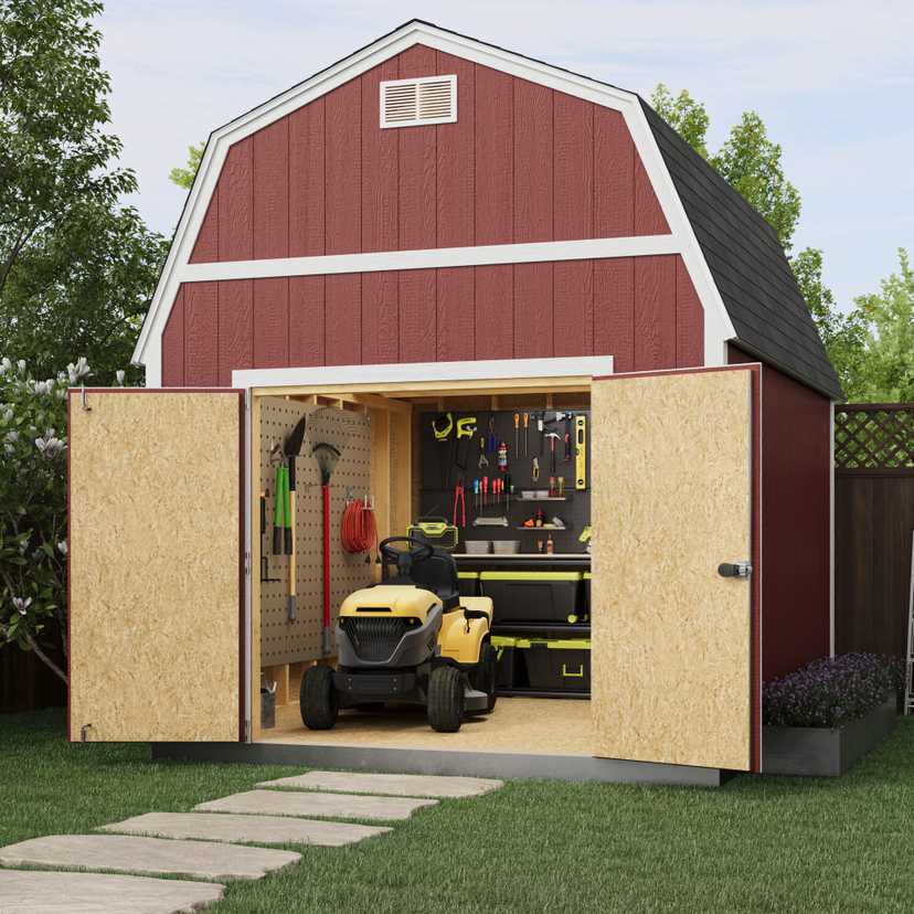A red barn-style shed with open doors, showing a yellow riding lawn mower and organized tools on the wall inside. A stone path leads to the shed.