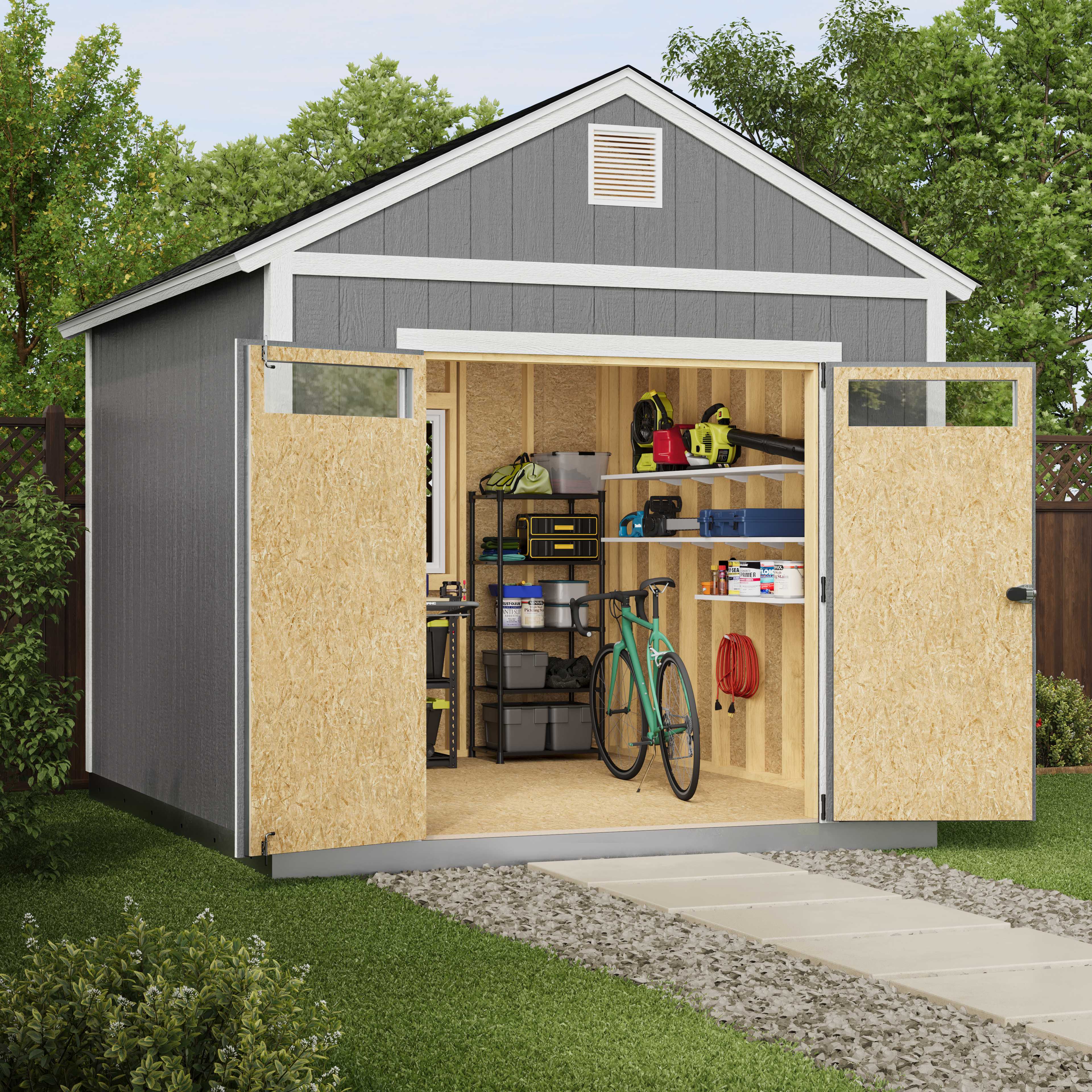Open shed with organized tools, a bicycle, and garden equipment inside. The pathway leads to the entrance, surrounded by green grass and trees.