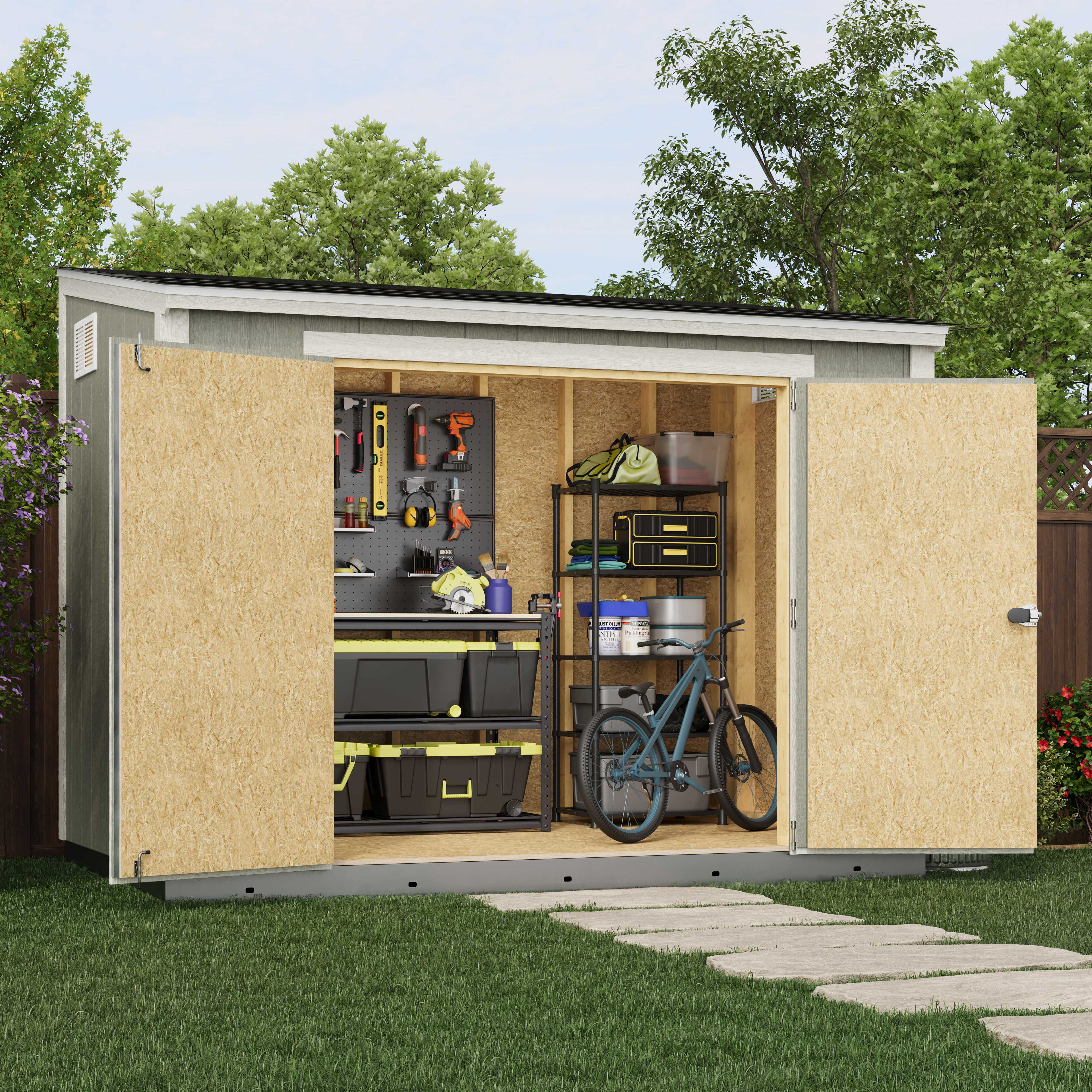 Outdoor shed with two open doors showing organized tools, storage bins, a bicycle, and a workbench. Surrounded by lush greenery and a wooden fence.