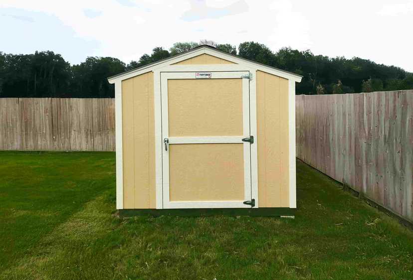 light yellow ranch style shed with white trim
