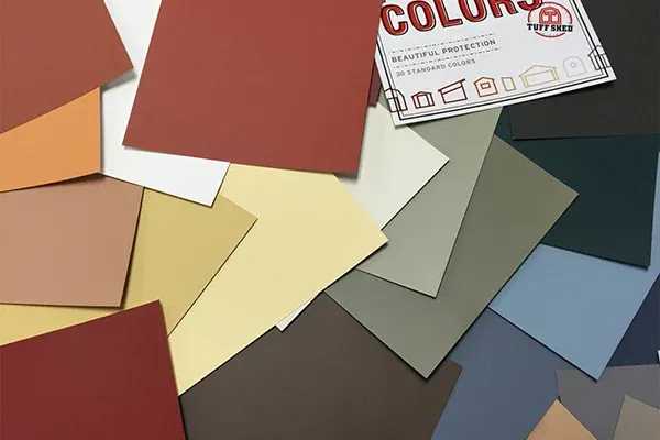 Assorted paint color swatches in various shades, including reds, yellows, greens, and blues, spread out with a color brochure.