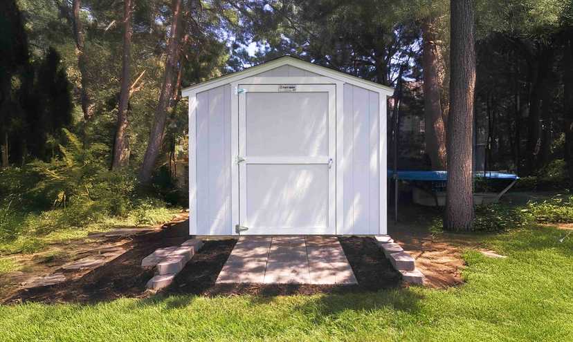 white shed in the backyard with brick landing