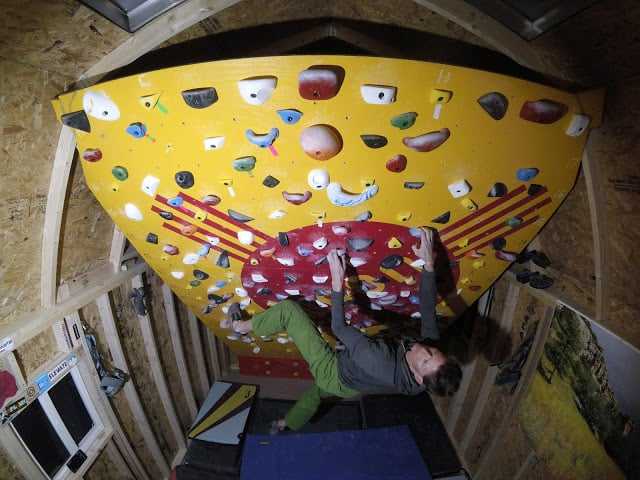 The moon board in action Person climbing an indoor moon bouldering wall
