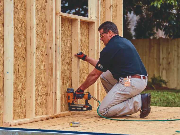 An home depot installer working on site installing a wall