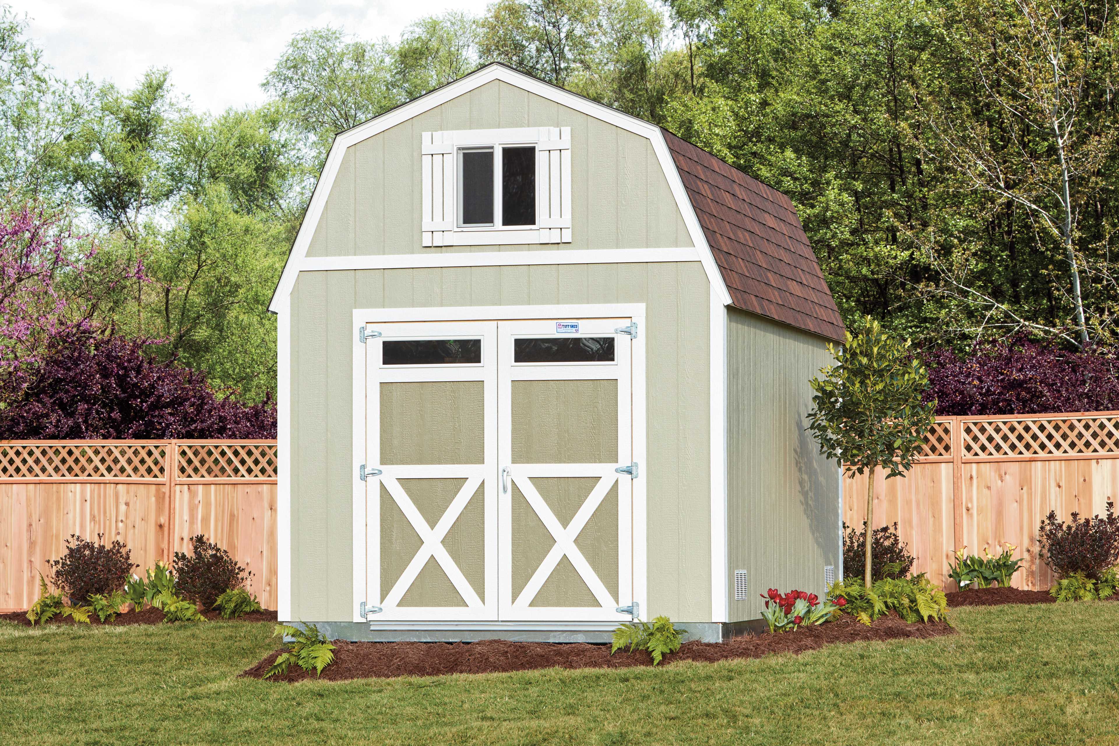 A TB700 shed with a brown shingled roof, white trim, and double doors